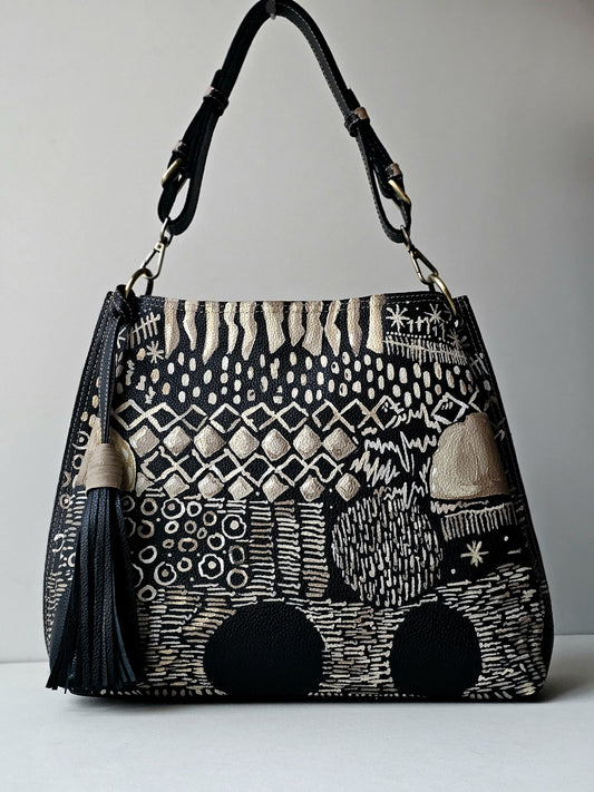 Leather bag with side tassel